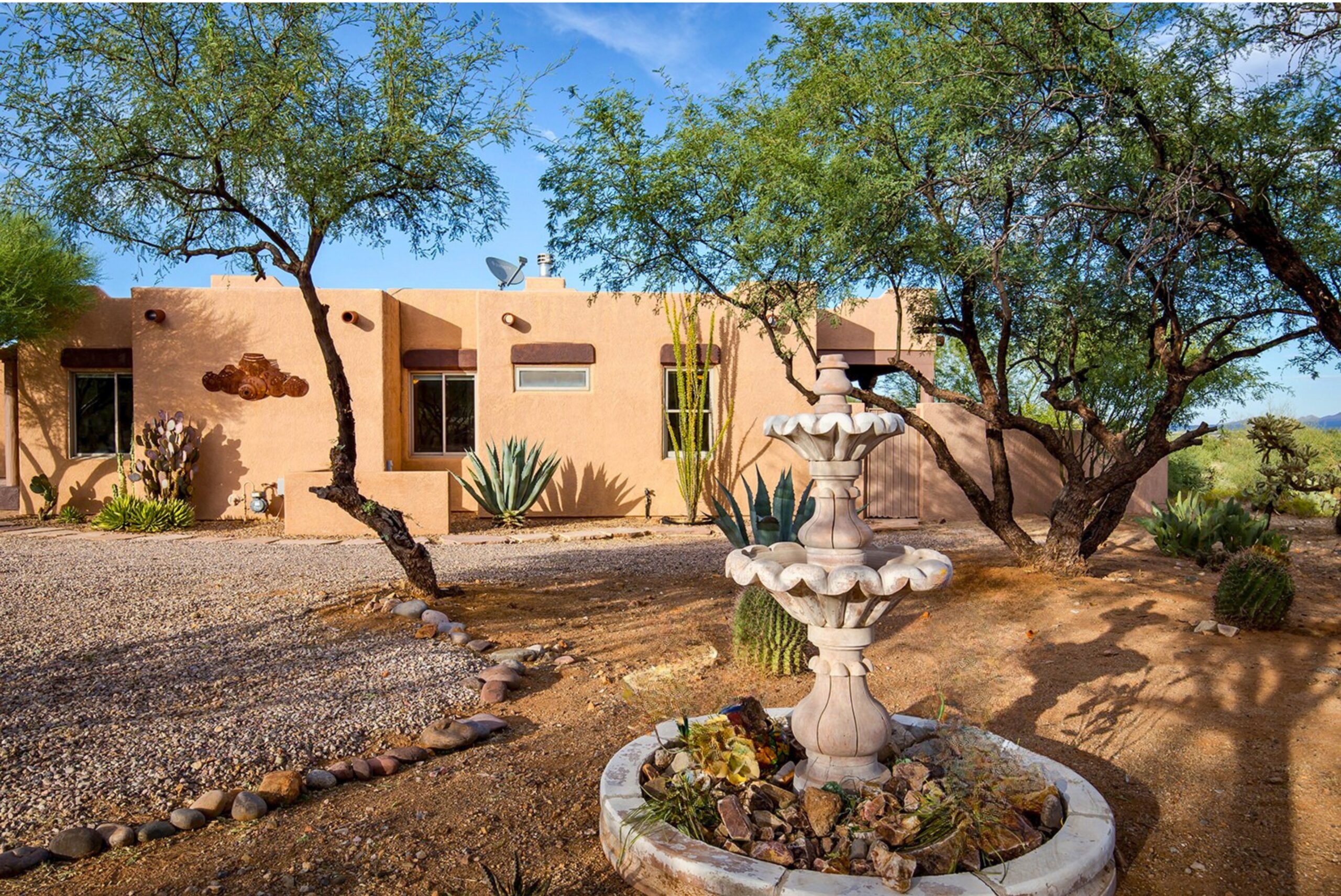 Southwestern home with mature mesquite trees and a courtyard fountain in Green Valley