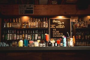 Image of a row of colorful drinks on the bar of the Tough Luck Club