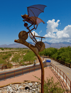 Image of a bat on a bicycle sculpture on the loop