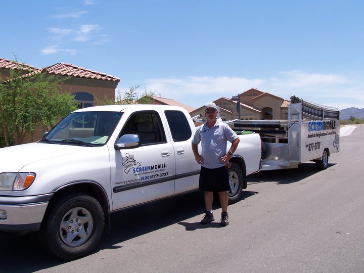 Sean, owner of Screenmobile Tucson, smiling in front of his service truck.