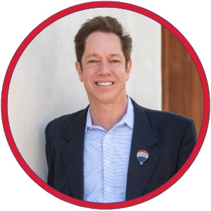 Tony Ray, a RE/MAX real estate expert, smiling in a professional headshot, representing AI innovation in real estate.