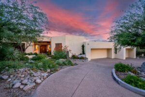 Catalina Foothills home with desert landscaping beneath a colorful Tucson sunset