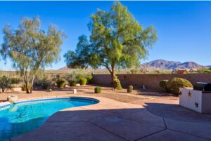 Vail Arizona backyard with a swimming pool, desert landscaping and mountain views